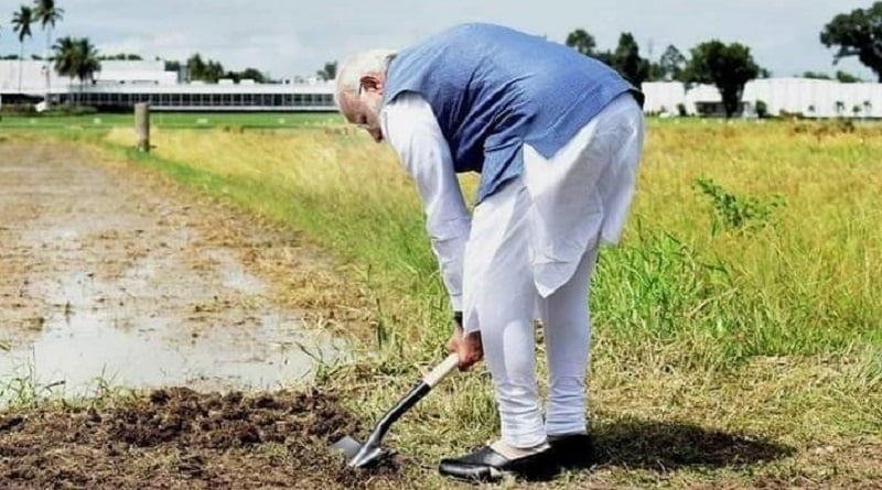 modi digging at a farm land