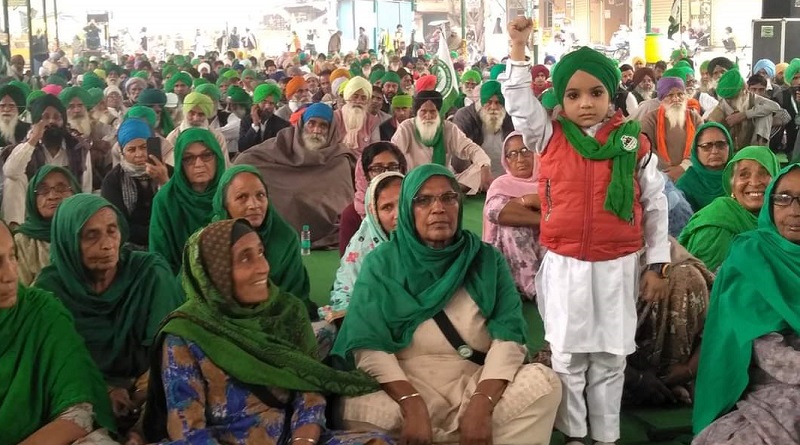 https://www.workersunity.com/wp-content/uploads/2021/12/Child-raising-hand-in-farmers-protest.jpg
