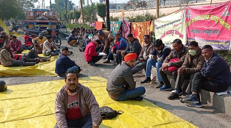 Interarch workers sat infront of company gate