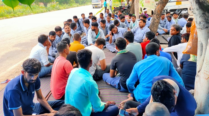 https://www.workersunity.com/wp-content/uploads/2023/07/Proterial-hitachi-worker-outside-factory-gate-in-Manesar.jpg