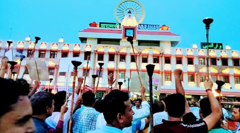https://www.workersunity.com/wp-content/uploads/2023/07/varanasi-NMOPS-torch-march-at-cant-railway-station-protest.jpg