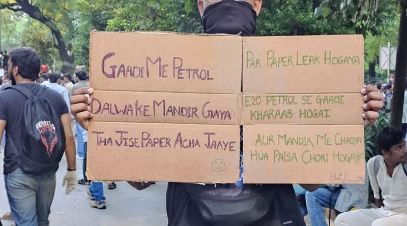 boy hold poster at jantar mantar display